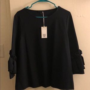 COS navy top with detailed sleeves